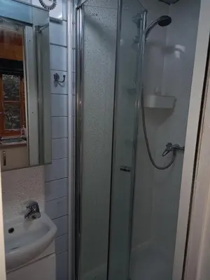 a bathroom with a shower and a toilet and a sink at The Nook in St Ives