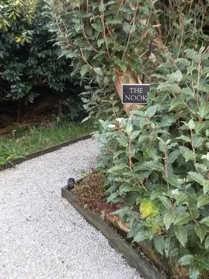 a garden with a sign that reads the now at The Nook in St Ives