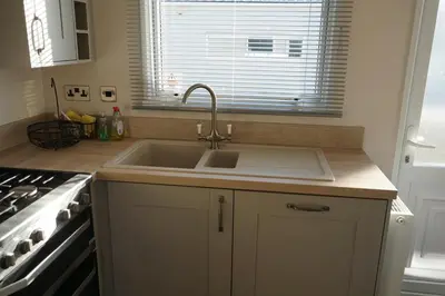 a kitchen with a sink and a stove at Sarahs Retreat in Par