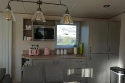 a kitchen with two lights hanging from the ceiling at Sarahs Retreat in Par