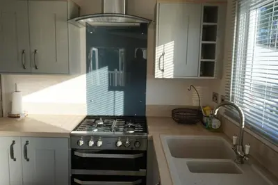 a kitchen with a stove and a sink at Sarahs Retreat in Par