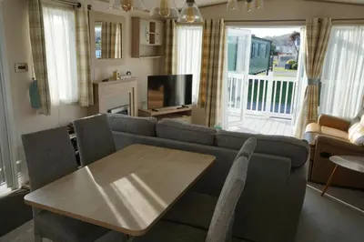 a living room with a couch and a table at Sarahs Retreat in Par