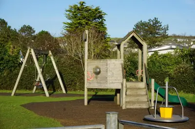 a wooden playground with a slide in a park at Sarahs Retreat in Par