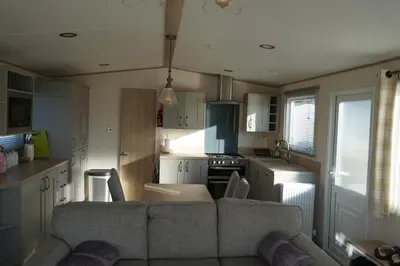 a living room with a couch in a kitchen at Sarahs Retreat in Par