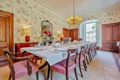 a dining room with a long table and chairs at 8 Bed in Tresillian oc-t32986 in Newlyn East