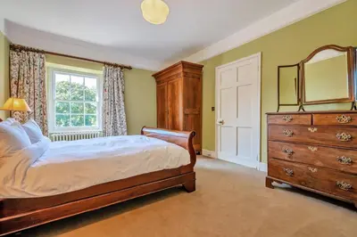 a bedroom with a bed and a dresser and a window at 8 Bed in Tresillian oc-t32986 in Newlyn East