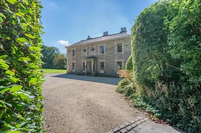 an old stone house with a large hedge at 8 Bed in Tresillian oc-t32986 in Newlyn East
