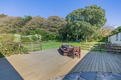 a wooden deck with a picnic table on it at 6 Bed in Tresillian oc-t32987 in Newlyn East