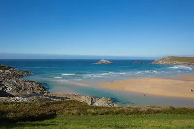 a beach with people on the sand and the ocean at 1 Bed in Tresillian oc-t32988 in Newlyn East