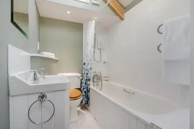 a bathroom with a sink and a toilet and a tub at 1 Bed in Tresillian oc-t32988 in Newlyn East