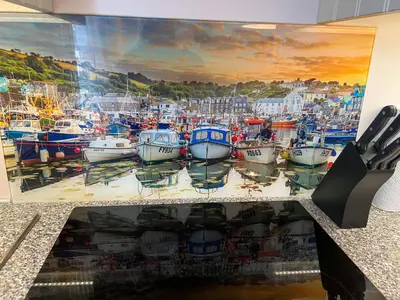 a large painting of boats in a harbor at Holiday Home Cherry Orchards by Interhome in Mevagissey