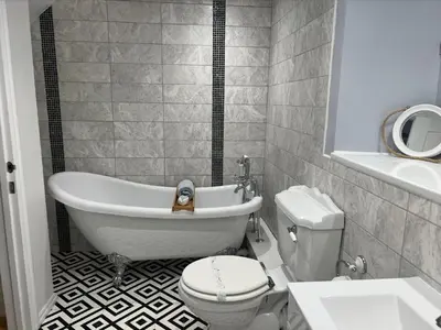 a bathroom with a tub and a toilet and a sink at Holiday Home Cherry Orchards by Interhome in Mevagissey