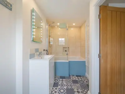 a bathroom with a tub and a sink and a shower at Holiday Home Cherry Orchards by Interhome in Mevagissey