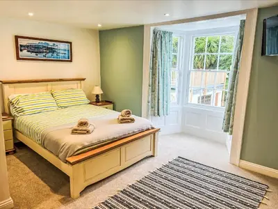 a bedroom with a bed with two teddy bears on it at Holiday Home Cherry Orchards by Interhome in Mevagissey