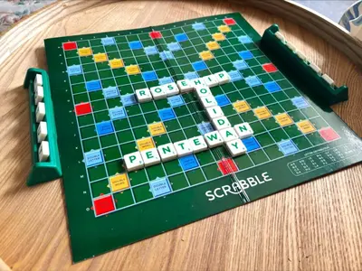 a board game on a wooden table at Holiday Home Rosehip Cottage by Interhome in Pentewan
