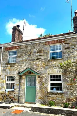 an old stone house with a green door at Holiday Home Rosehip Cottage by Interhome in Pentewan