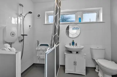 a white bathroom with a toilet and a sink at Finest Retreats - Sea Thrift at Widemouth Bay in Widemouth Bay