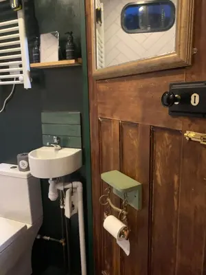 a bathroom with a sink and a toilet at Rosies in Liskeard