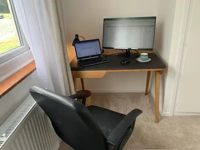 a desk with a laptop and a monitor and a chair at 2 Bed-Sleeps 4-Parking-Pets-10 min walk to Beach in Falmouth