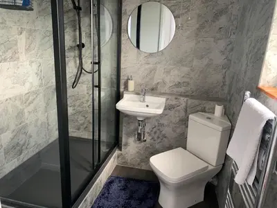 a bathroom with a shower and a toilet and a sink at 2 Bed-Sleeps 4-Parking-Pets-10 min walk to Beach in Falmouth
