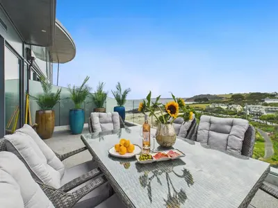 a table with a plate of fruit on a balcony at Skydeck at The Liner – Stylish 2-Bed / 2-Bath Top Floor with Panoramic Sea Views in Falmouth