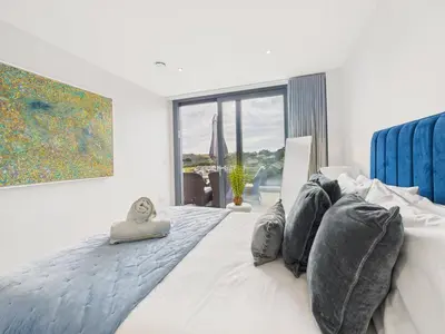 a bedroom with a bed and a large window at Skydeck at The Liner – Stylish 2-Bed / 2-Bath Top Floor with Panoramic Sea Views in Falmouth