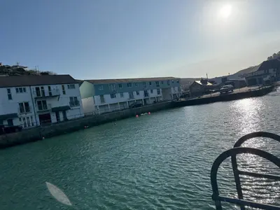 a view of a river with buildings in the background at Harbour Edge in Portreath