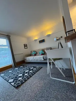 a living room with a couch and a table at Harbour Edge in Portreath