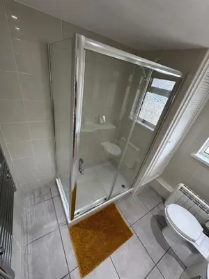 a bathroom with a shower and a toilet at Harbour Edge in Portreath