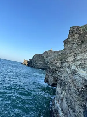 a view of the ocean next to a rocky cliff at Harbour Edge in Portreath