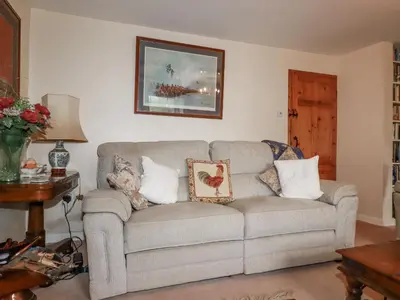 a living room with a couch with pillows on it at Temple House in Truro