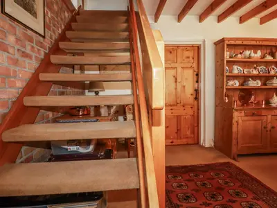 a staircase in a home with a brick wall at Temple House in Truro