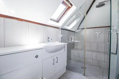 a bathroom with a sink and a shower at Temple House in Truro