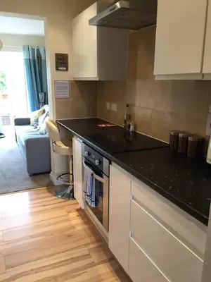 a kitchen with a black counter top in a room at Tolcarne Reach in Newquay