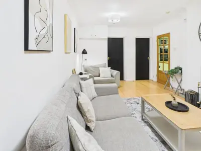 a living room with a couch and a table at Riviera Cottage - Cornwall in Portreath