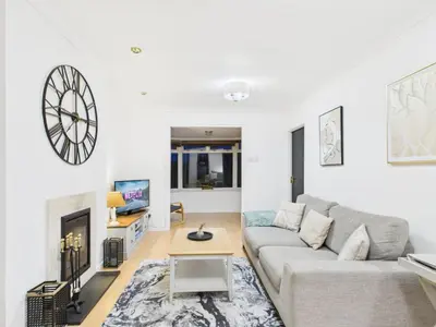 a living room with a couch and a fireplace at Riviera Cottage - Cornwall in Portreath