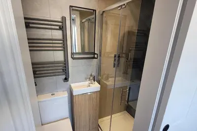 a bathroom with a shower and a sink and a mirror at Looe Cottage - Seaside views log fire sleeps 4 in Looe