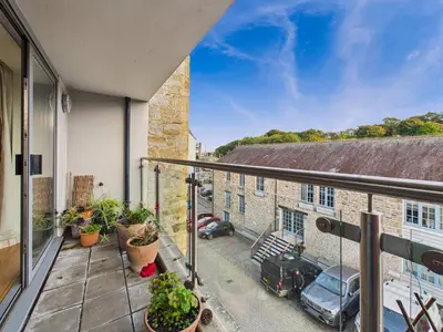 an apartment balcony with a view of a garage at Penryn Quayside Apartment – 1-bed, Fully Equipped Waterside base in Penryn