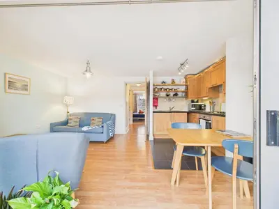 a kitchen and living room with a table and chairs at Penryn Quayside Apartment – 1-bed, Fully Equipped Waterside base in Penryn