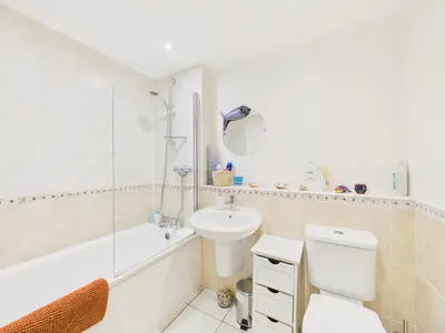 a bathroom with a toilet and a sink and a shower at Penryn Quayside Apartment – 1-bed, Fully Equipped Waterside base in Penryn