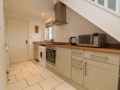 a kitchen with a microwave oven and a stove at Atlantic View Annex in Bude
