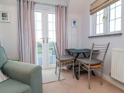 a living room with a table and chairs and a couch at Atlantic View Annex in Bude