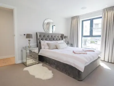 a bedroom with a large bed and a window at Beach View Fistral in Newquay