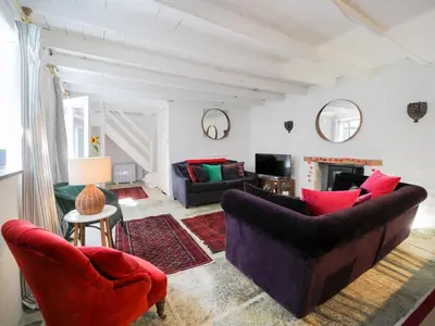 a living room with two couches and a fireplace at Kernyck in Port Isaac