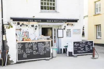 a coffee shop with two signs in front of it at Kernyck in Port Isaac