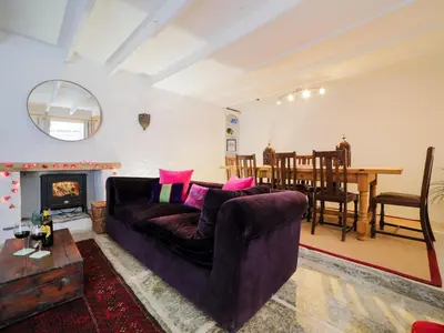 a living room with a couch and a table at Kernyck in Port Isaac