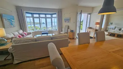 a living room with a couch and a table at Highlands in Saint Mawes