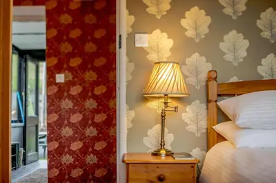 a bedroom with a bed and a lamp on a table at 1 Bed in Two Waters Foot oc-a27332 in Warleggan