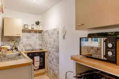 a kitchen with a sink and a microwave at 1 Bed in Two Waters Foot oc-n27333 in Warleggan