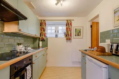 a kitchen with green and white tiles on the wall at 2 Bed in Two Waters Foot oc-s27334 in Warleggan